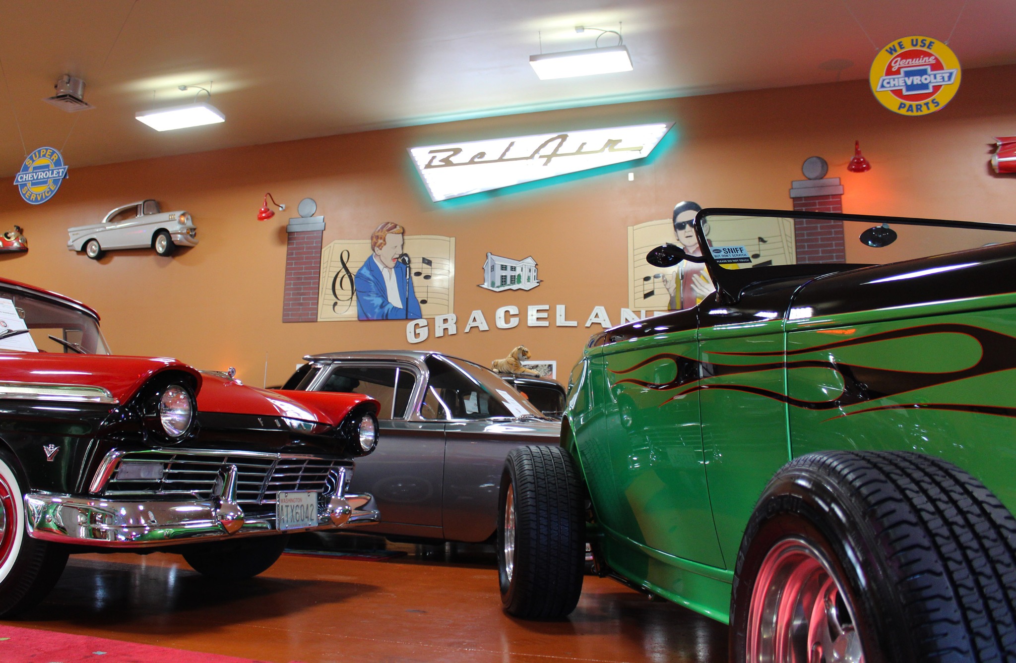 Classic cars and a green flame-painted hot rod in the former showroom